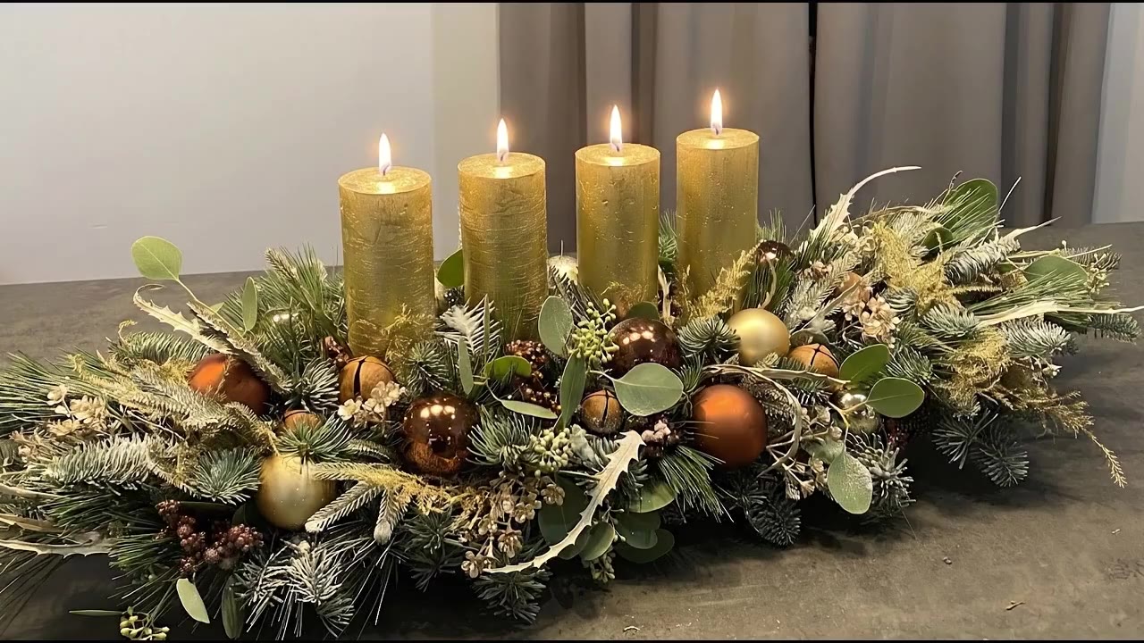 Long Advent candle holder with four lit gold candles and copper baubles